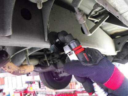 a man is working on the underside of a vehicle